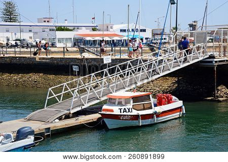 Olhau, Portugal - June 12, 2017 - Water Taxi Moored Alongside A Ramp Against The Avenida 5 De Outubr