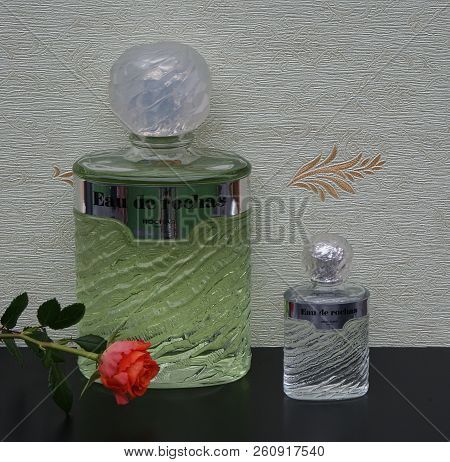 Eau De Rochas, Fragrance For Ladies, Large Perfume Bottle Next To A Commercial Perfume Bottle In Fro