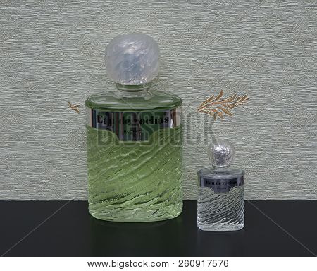 Eau De Rochas, Fragrance For Ladies, Large Perfume Bottle Next To A Commercial Perfume Bottle In Fro