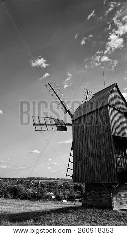 High Old Wooden Mill In The Field In Black And White Colors