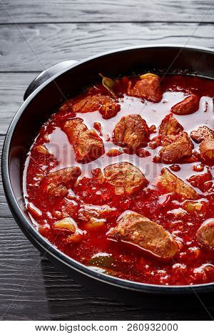 Hearty Red Chile And Pork Stew Or Carne Adobada In A Dutch Oven On A Black Wooden Table, Mexican Cui