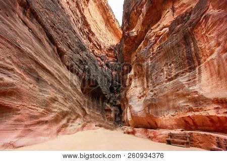 Great High Reddish-orange Rock Mountains Of Ancient City Petra, Jordan, Outdoor, Sunny Day. Rock Wal