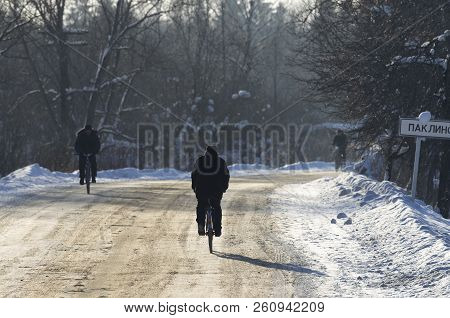 City Of Dno, Pskov Oblast (russia) - February 22, 2018: Unidentified Locals Men Ride Bicycles On The