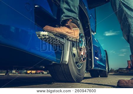 Truck Driver Concept. Driver Getting Into The Semi. Legs Closeup.