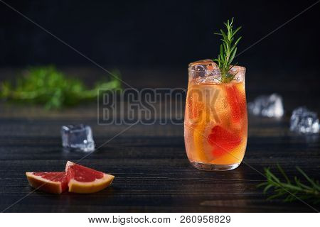 Gin Cocktail With Rosemary And Grapefruit On A Black Background, Selective Focus.