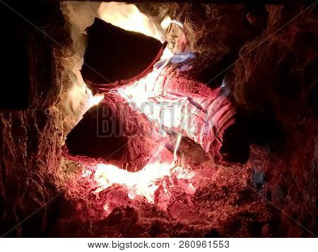 Beautiful Red Flame From Slice Wood, Dark Grey Black Coals Inside Metal Brazier. Wood Burning In The
