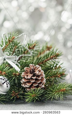 Silver Christmas Background Of Defocused Bokeh Lights With Decorated Fir Tree Branches