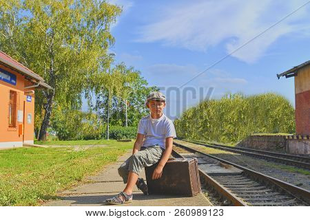 Little Boy  On A Railway Station, Waiting For The Train With Vintage Suitcase. Traveling, Holiday An