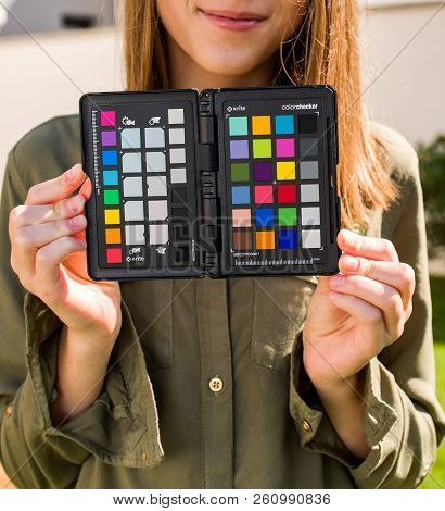 Paris, France - Sep 30, 2018: Professional Model Holding Color Passport By X-rite Color Reference Ta
