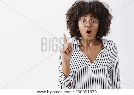 Smart And Creative Artistic African American In Striped Office Blouse And Glasses Raising Index Fing