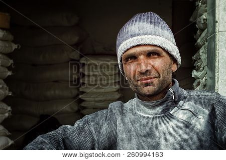 Lankaran, Azerbaijan - Apr 18 2011: Local Man In Front Of His Produce In Large Bags At The Farmer Ma