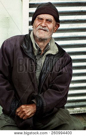 Lankaran, Azerbaijan - Apr 18 2011: Local Man In Front Of His Closed Store Front At The Local Market