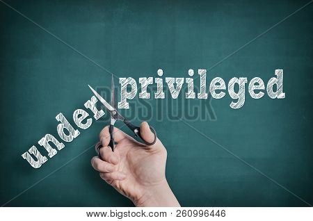 The Male Hand With Scissors Cuts Word Privileged From Underprivileged
