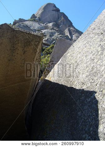Granite Rocks Closeup, Natural Texture Pattern With Blue Sky In The Background