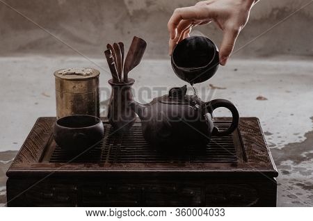 Cropped Shot Of Woman Pouring Tea In Traditional Chinese Teaware