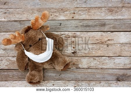 Plush Reindeer Wearing Medical Protective Mask A Conceptial Image Of Health Threat And Global Pandem