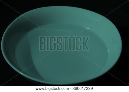 White Bowl Filled With Water On Black Background
