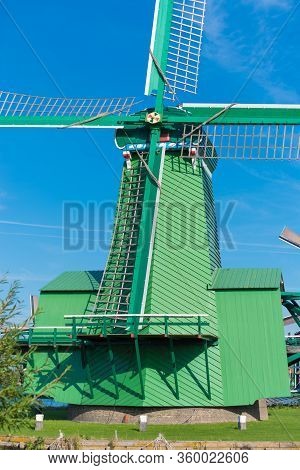 Traditional Windmill In The Zaanse Schans, A Neighborhood With Historic Wooden Buildings In The Muni