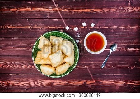 Baursak - Traditional Kazakh Asia Food National Bread In Plate With Tea On Wooden Background. Top Vi
