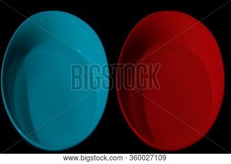 Two Bowls With Water Of Different Colors,