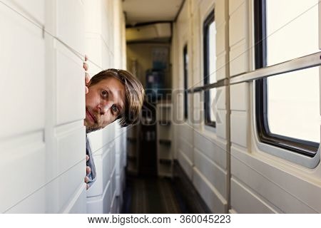 Portrait Of Cheerful Beard Man On The Train. Looking At Camera. Curious Fellow Traveler From A Nearb