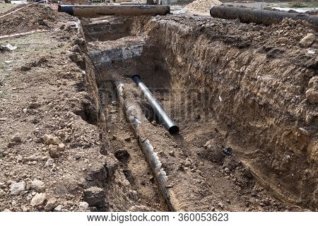 repair and replacement main pipeline of heating systems, district heating pipes network, water supply or Sewerage in city, removing old pipes and replacing them with new ones in a hole in the ground