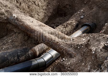 repair and replacement main pipeline of heating systems, district heating pipes network, water supply or Sewerage in city, removing old pipes and replacing them with new ones in a hole in the ground