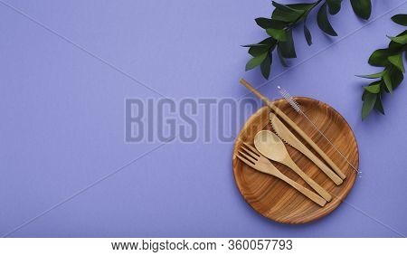 Wooden Utensils. Plate And Cutlery On Violet Background, Free Space