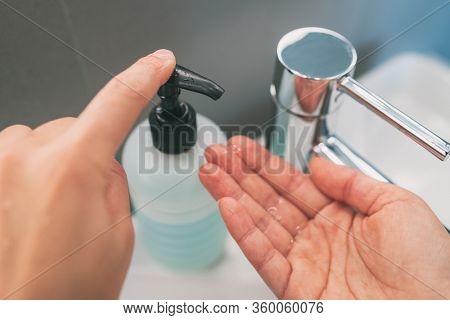 Washing hands with soap how to wash step 2 : squirt liquid from soap bottle dispenser for rubbing hands together.