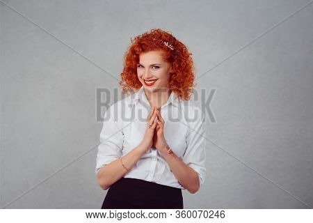 Plot. Closeup Portrait Of Sneaky, Sly, Scheming Young Woman Plotting Something Isolated On Gray Wall