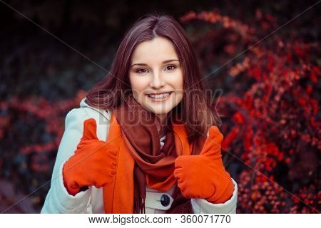 Woman Outdoors Showing Like Thumbs Up Gesture With Both Hands Outdoors Green Shrub With Red Berries 