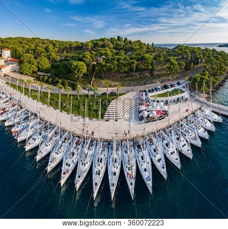 Croatia, Maslinica, 15 September 2019: Drone View Point On Moored In An Equal Row Sailboats At Sunse