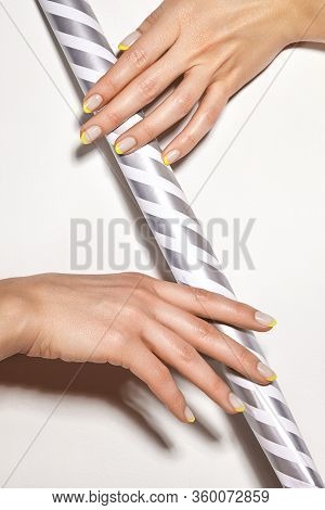 Hands With Bright Yellow French Manicure. Nails Art Design. Close-up Of Hands With Trendy Neon Nails