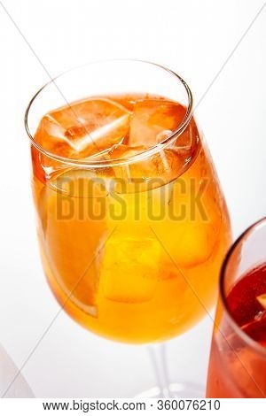 Spritz fruit cocktails. Alcohol soft drinks in glasses side view. Refreshment beverage with coconut, berry, orange in drinkware. Exotic summer beach cocktail portions with crushed ice in glassware