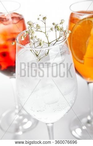 Spritz fruit cocktails. Alcohol soft drinks in glasses side view. Refreshment beverage with coconut, berry, orange in drinkware. Exotic summer beach cocktail portions with crushed ice in glassware