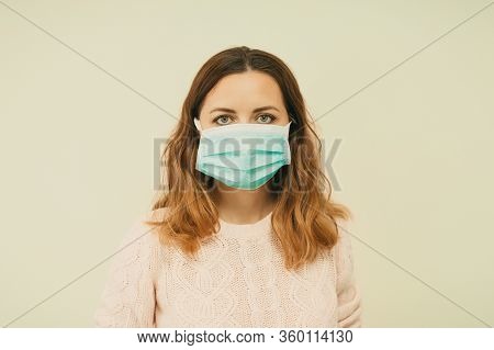 Portrait Of A Young Woman Wearing A Protective Medical Face Mask, Looking At Camera, Close Up, Isola