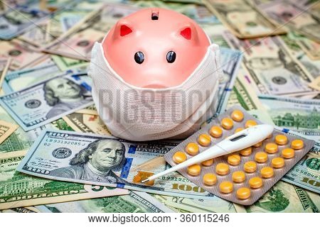 Piggy Bank In A Mask On A Background Of American Currency.the Concept Of Coronavrius Epidemic