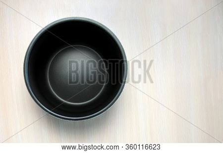 Modern Multi Cooker Empty Inner Bowl On A Light Wooden Table. Place For Text