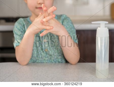 Kid Girl Is Spraying Sanitaizer Or Alcohol Gel On Her Hands. Antiseptic Cleaning Gel In Child's Hand