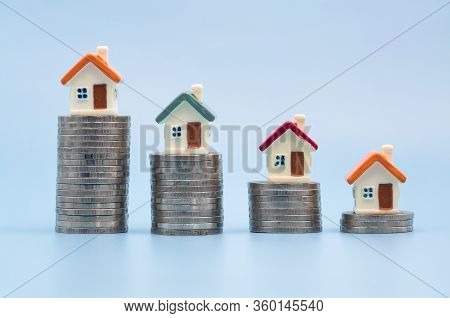 Mini House On Stack Of Coins, Money And House,  Mortgage, Savings Money For Buy House And Loan To Bu