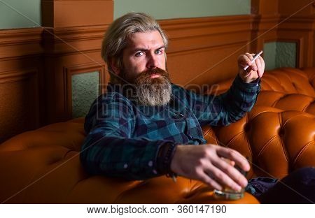 Luxury And Success. Smoke Cigarette While Drink Brandy Or Cognac. Hard Beverage For Real Men. Brutal