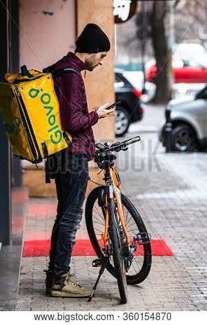 A Glovo Food Delivery Courier On A Bike. Restaurants Are Closed And Only Deliveries Are Allowed Duri