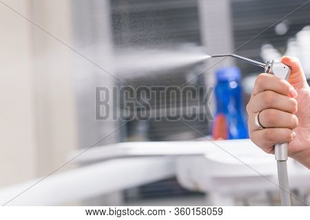 Dentistry, Dental Health And Medicine Concept - Close-up Of Dentists Hand Holding A Dental Tool Inst