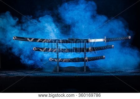 Three Swords On Stand, One Blade Partially Visible