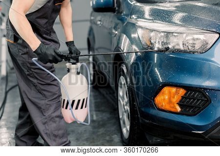 Washing Car, Detailing Concept. Close Up Image Of Male Car Wash Worker Wearing Gray Overalls Doing C