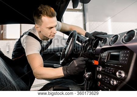 Car Detailing Concept. Brush Cleaning Off Dust From The Car Interior Details, Control Panel. Young C