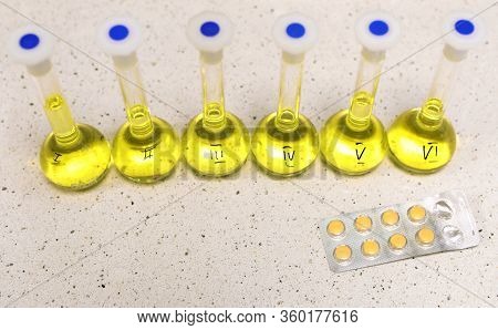 Conducting A Chemical Experiment In A Laboratory. Colored Flasks With Chemical Reagents. Many Glass 