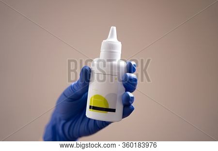 Treatment Of Hands With An Antiseptic Gel. Side View Of Hands In Rubber Gloves With Alcohol Gel On A