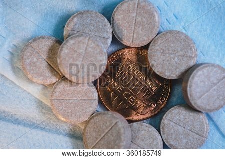 One Cent Coin With Pills On A Medical Mask