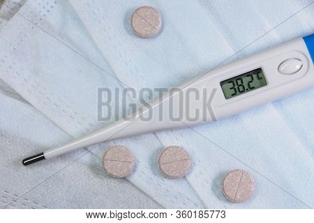 Electronic Thermometer And Pills With A Medical Mask